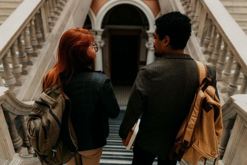 Two students walking down a historic staircase in Buenos Aires, Argentina.