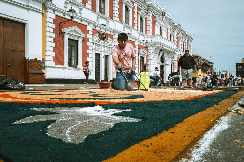 Artisans create vibrant street art during a cultural festival in Trujillo, Peru.