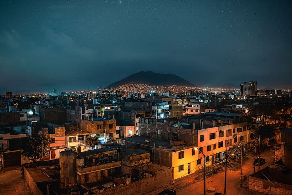 A captivating night view of Trujillo, Peru, featuring a vivid cityscape under a starry sky.