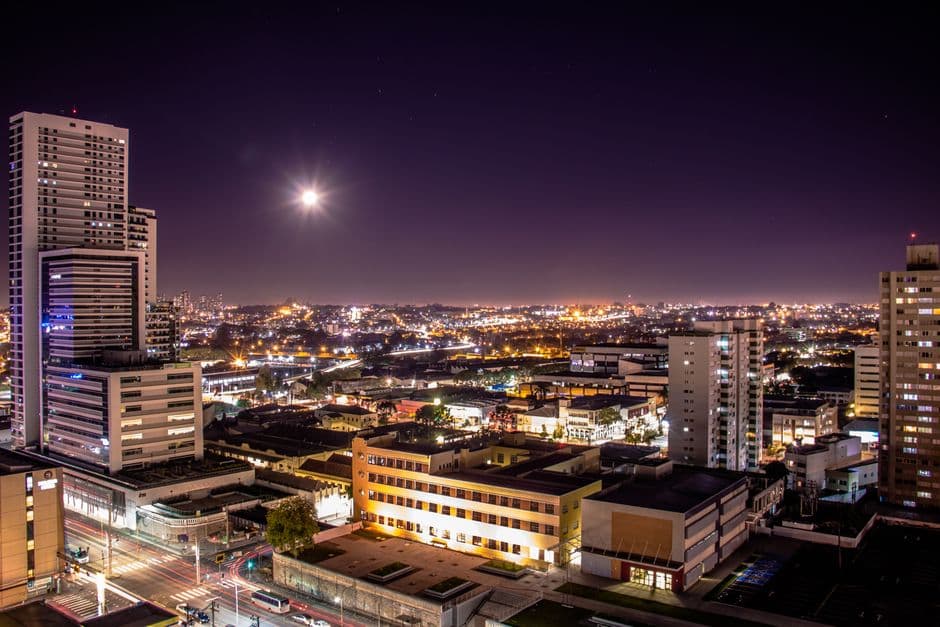 Stunning aerial view of Curitiba at night showcasing illuminated skyscrapers and vibrant city life.