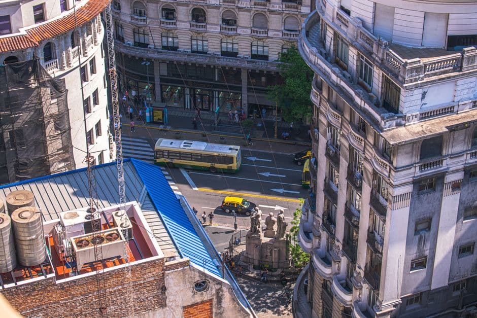 Aerial view of a bustling Buenos Aires street with classic architecture, showcasing urban life.