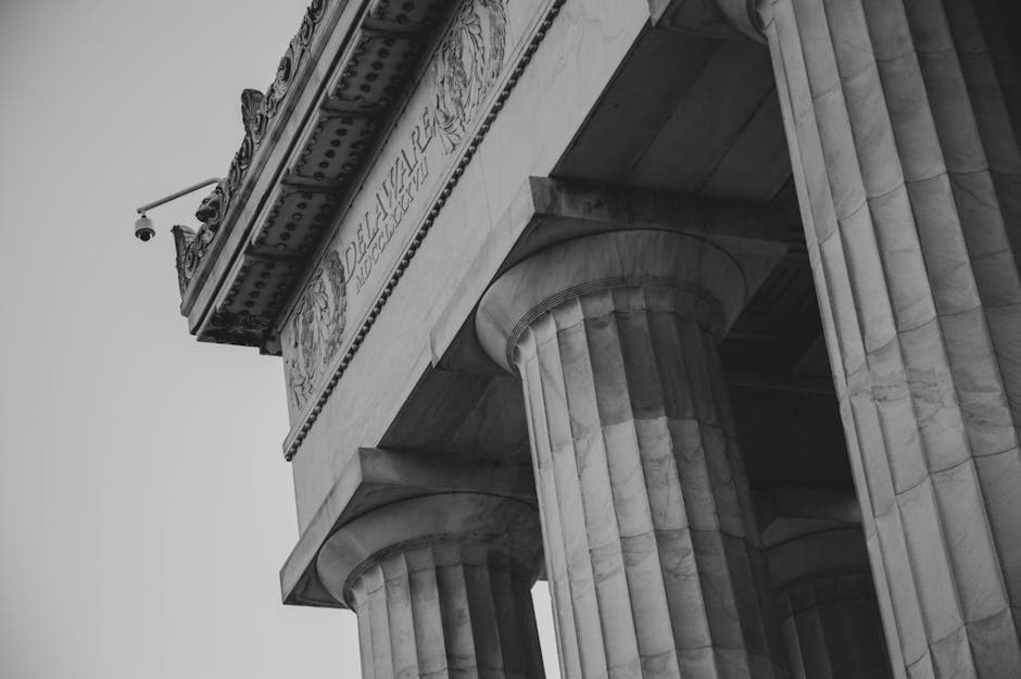 Low angle view of Lincoln Memorial columns in monochrome, showcasing neoclassical architecture.