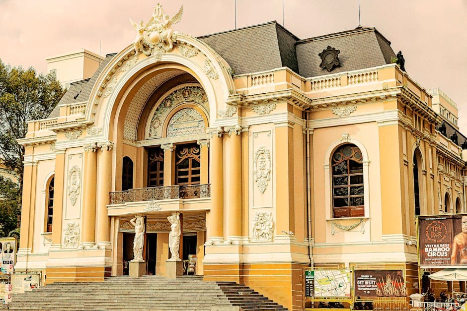 The elegant facade of the Saigon Opera House in Ho Chi Minh City under a clear sky.