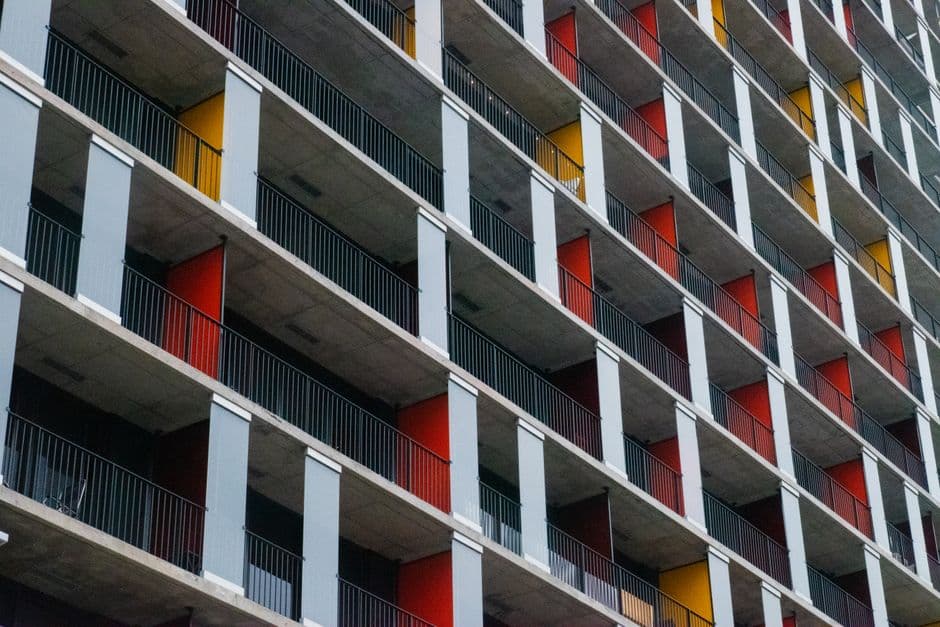 A visually striking exterior of a modern apartment building with colorful balconies.