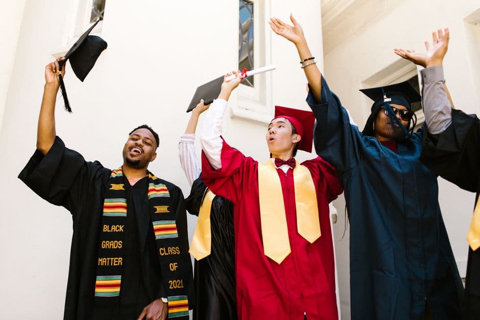 Graduates celebrating with caps and diplomas, expressing joy and achievement.