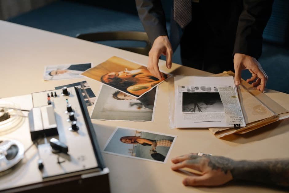 A detective examines evidence and photos during an investigation.