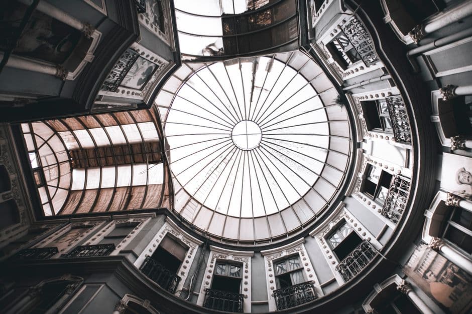 Captivating view of a historic glass dome in the Çiçek Pasajı, Istanbul, featuring French style architecture.