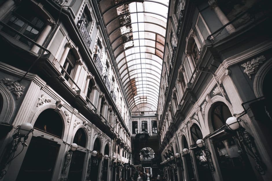A striking view of a historic glass-roofed arcade in Istanbul, Turkey, showcasing intricate architecture.