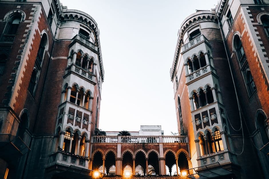 A low-angle view of gothic architectural buildings in Istanbul with warm evening lights.
