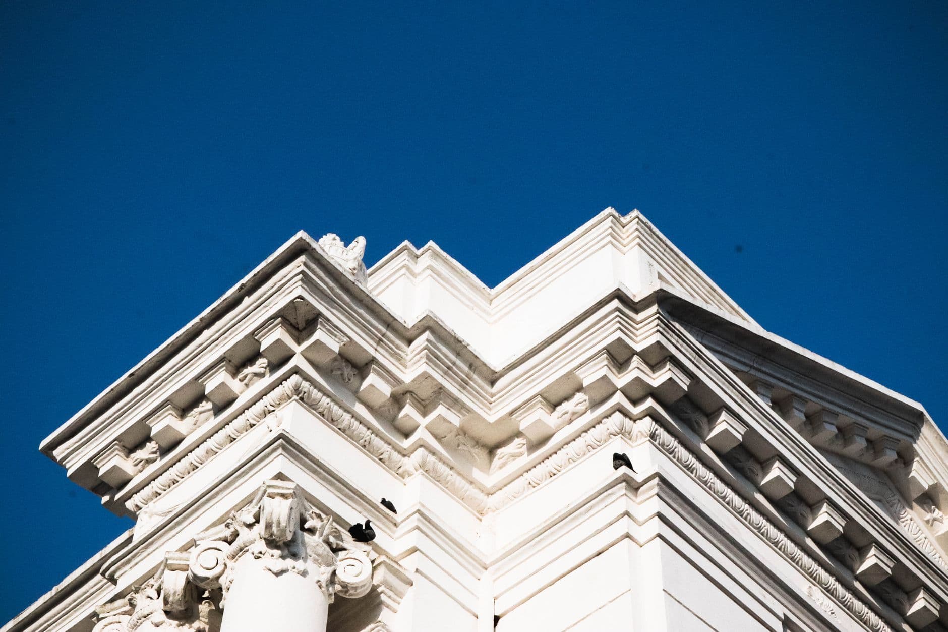 Detailed view of neo-classical architecture against a clear blue sky in Kathmandu.