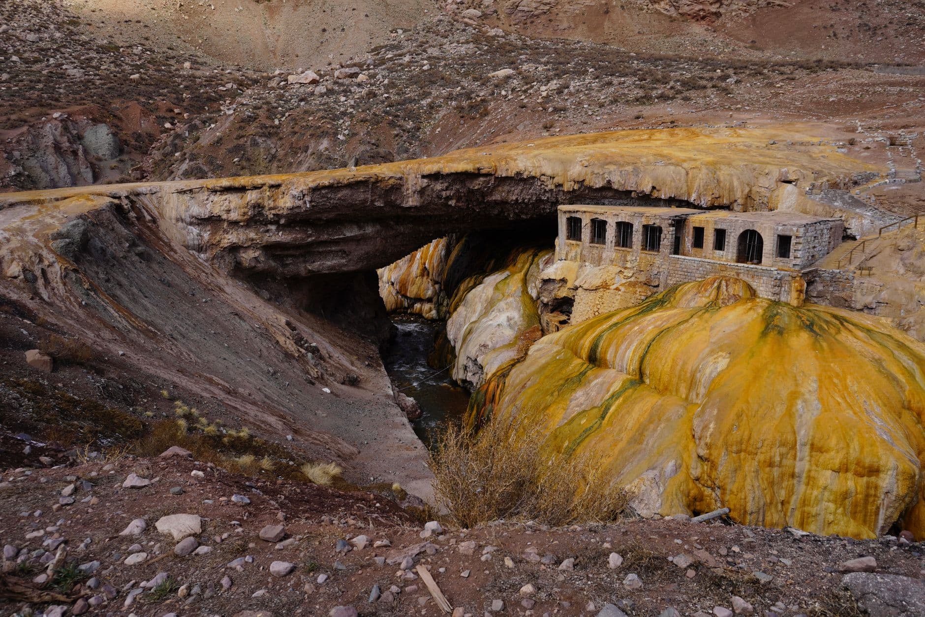 Historic Puente del Inca natural bridge and ruins in Mendoza, Argentina, with striking mineral deposits.