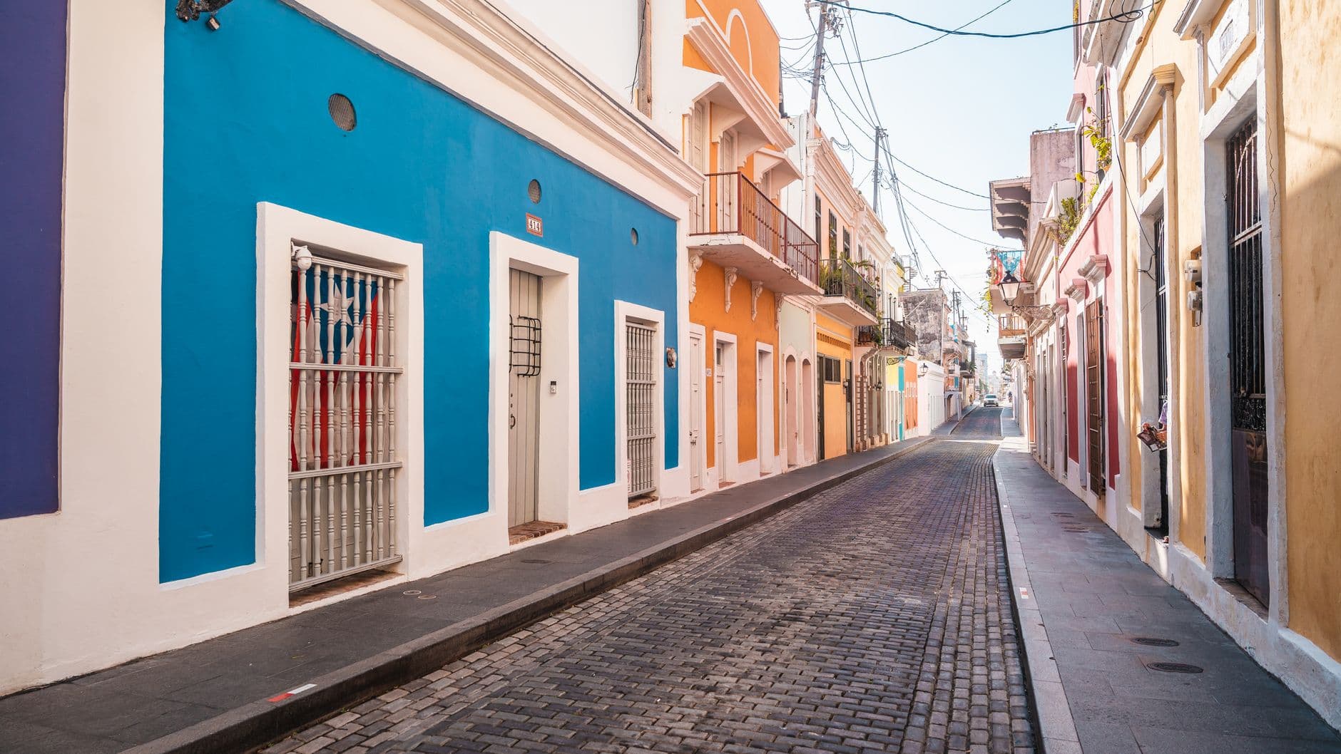 A picturesque street view showcasing colorful buildings in a historic old town alley during the day.
