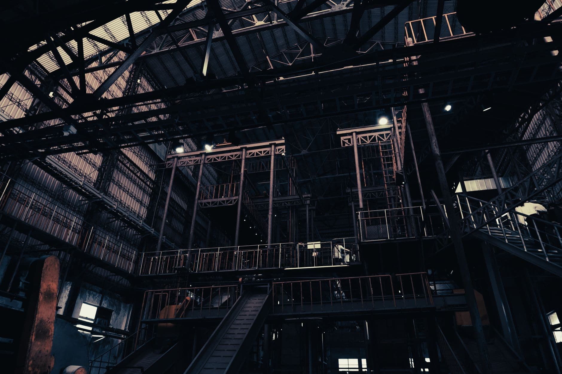 Low angle view of a dimly lit factory interior, showcasing industrial architecture in Pingtung, Taiwan.