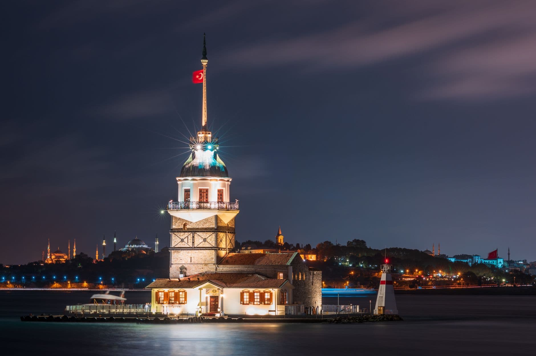 Majestic night view of the illuminated Maiden's Tower on the Bosphorus Strait in Istanbul.