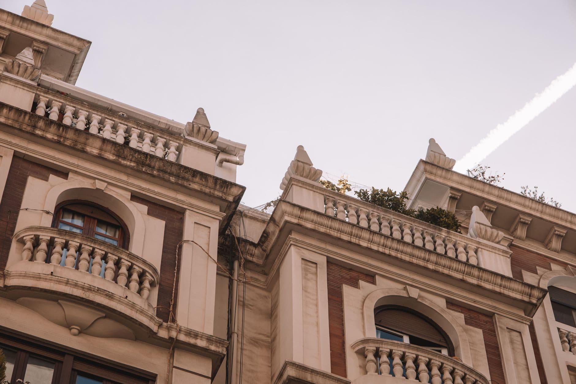 Detailed view of elegant balconies on a building in Valencia, Spain, showcasing classic architectural design.