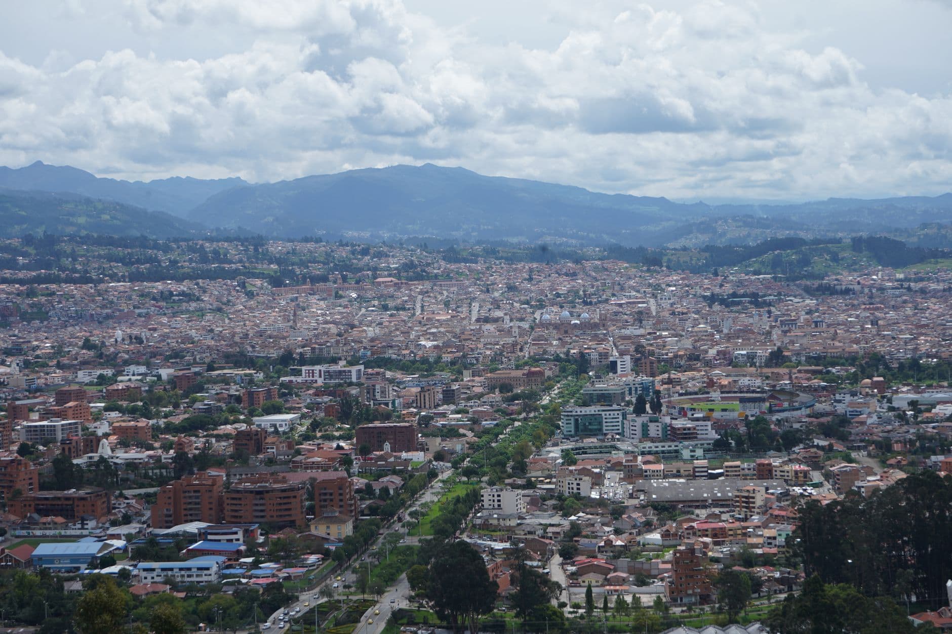 Stunning aerial view of Cuenca, Ecuador showcasing its dense urban landscape and mountainous backdrop.