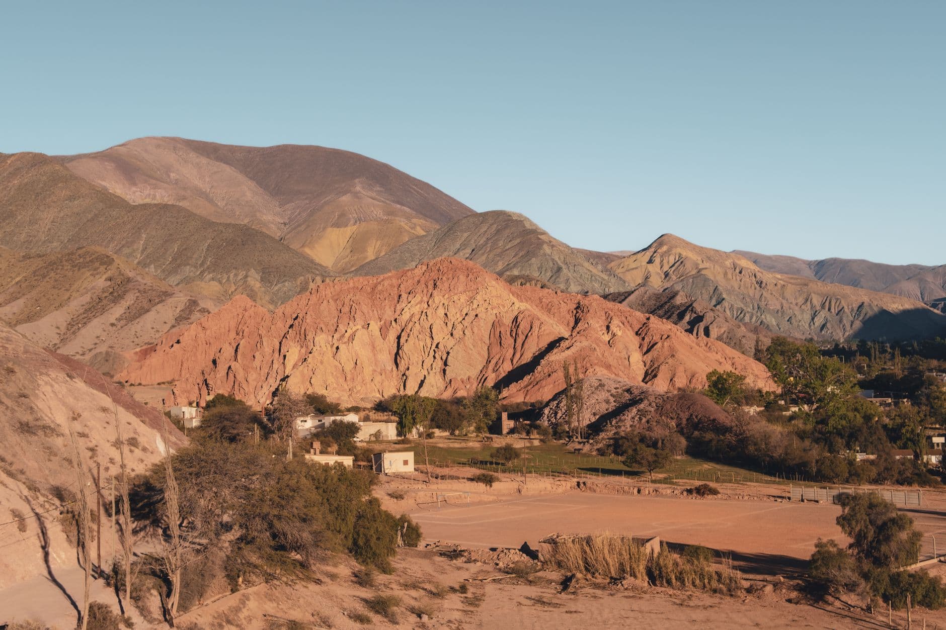 Beautiful aerial view of the colorful hills in Jujuy, Argentina, capturing the unique geological formations and tranquil village.