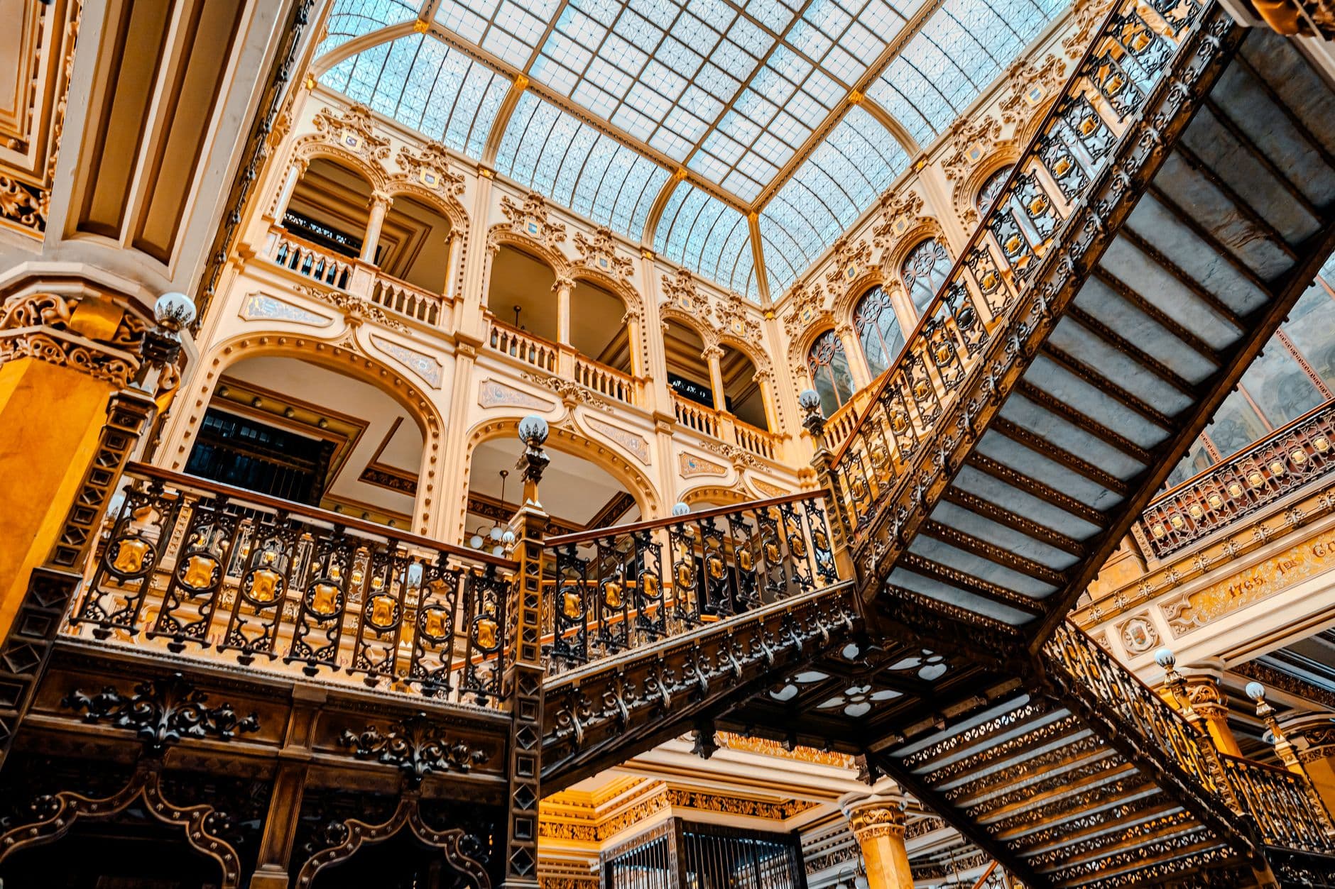 Interior view of the striking ornate staircase in Mexico City's Palacio Postal, showcasing intricate architectural details.