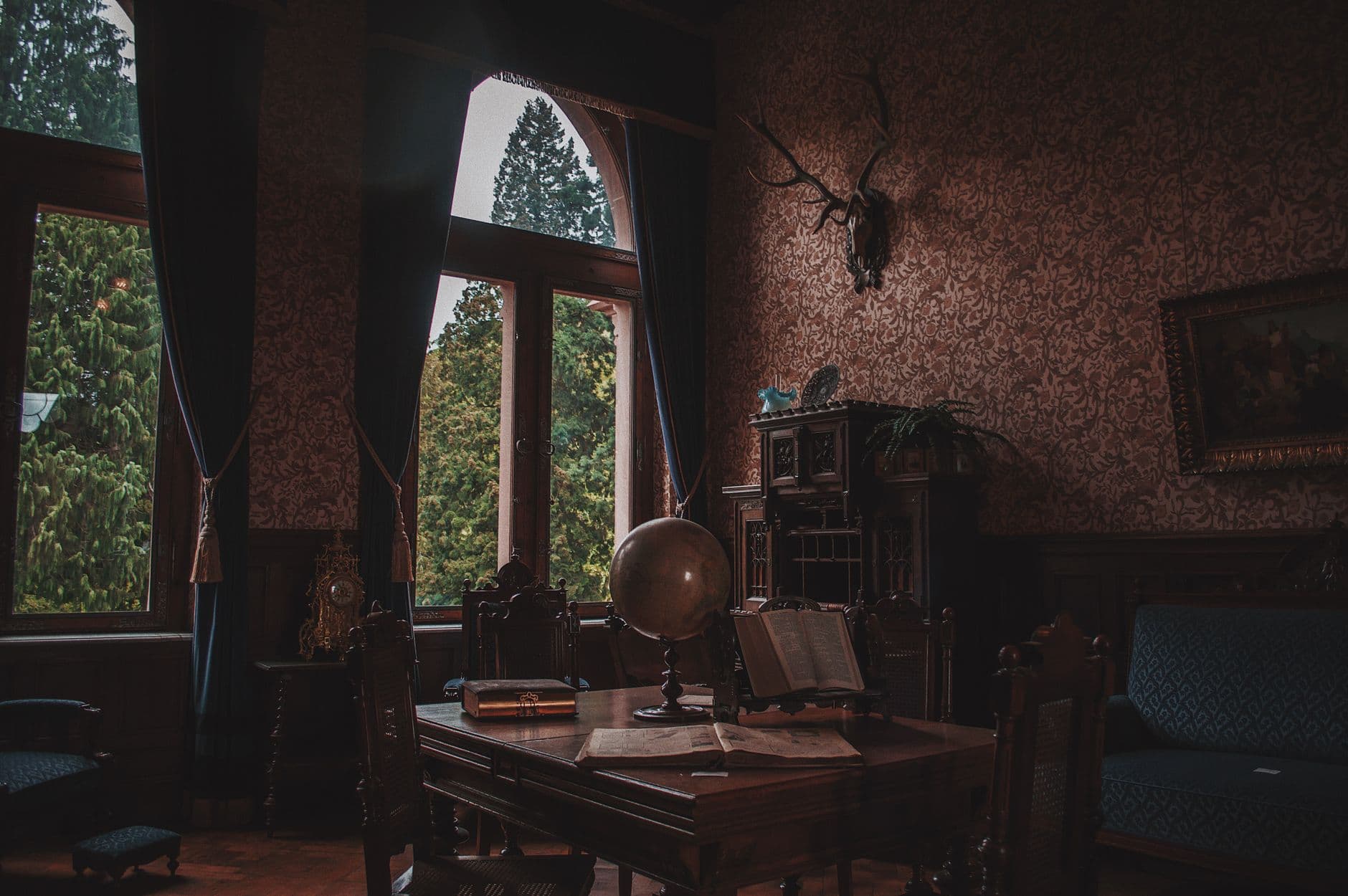 Elegant vintage study room featuring antique decor and wooden furnishings, perfect for a classic ambiance.