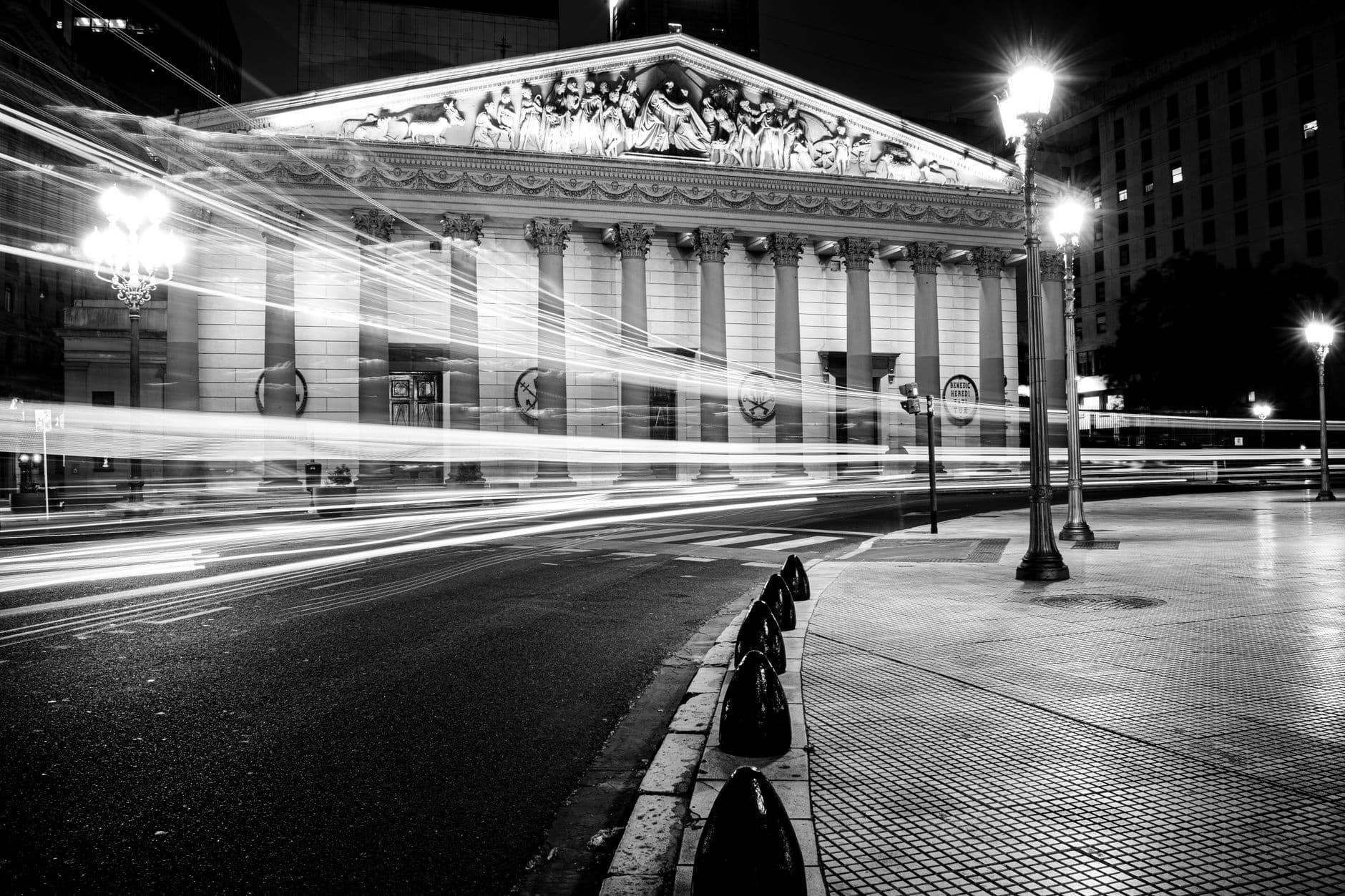 Long exposure captures light trails near Buenos Aires Cathedral at night.