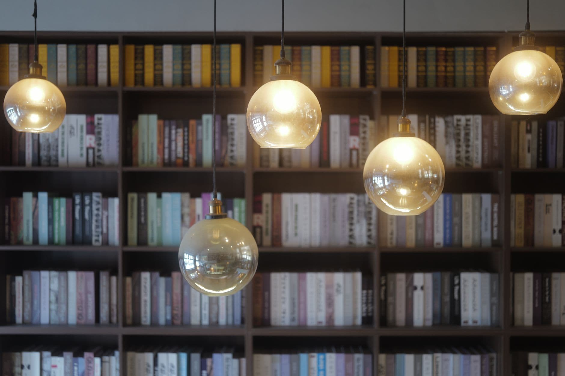 Warm ambient lighting in a home library with bookshelves.