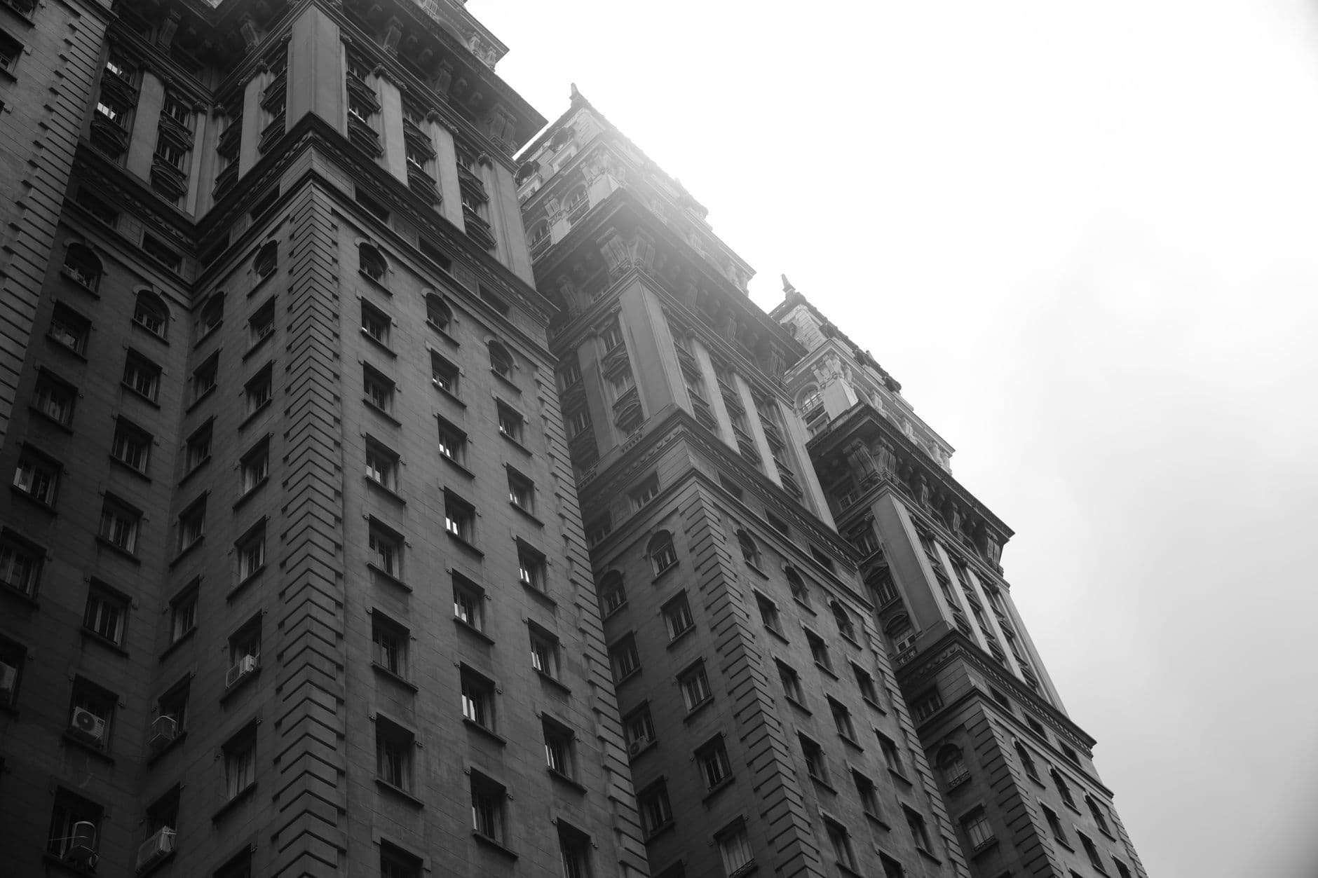 Black and white photo of a towering skyscraper with dramatic perspective.