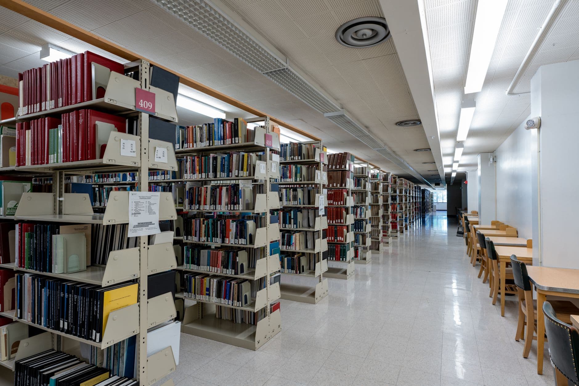 Interior view of a university library with bookshelves and study areas in Pullman.