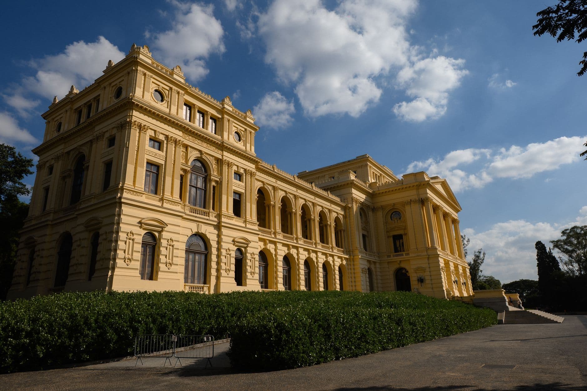 Elegant historic yellow building under bright blue sky, captured in daylight.