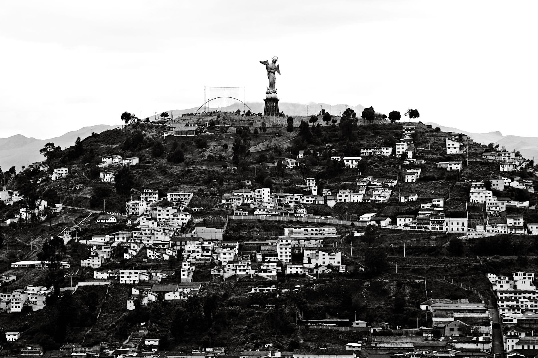 Black and white panoramic view of El Panecillo Hill and the Virgin of Quito statue in Ecuador.