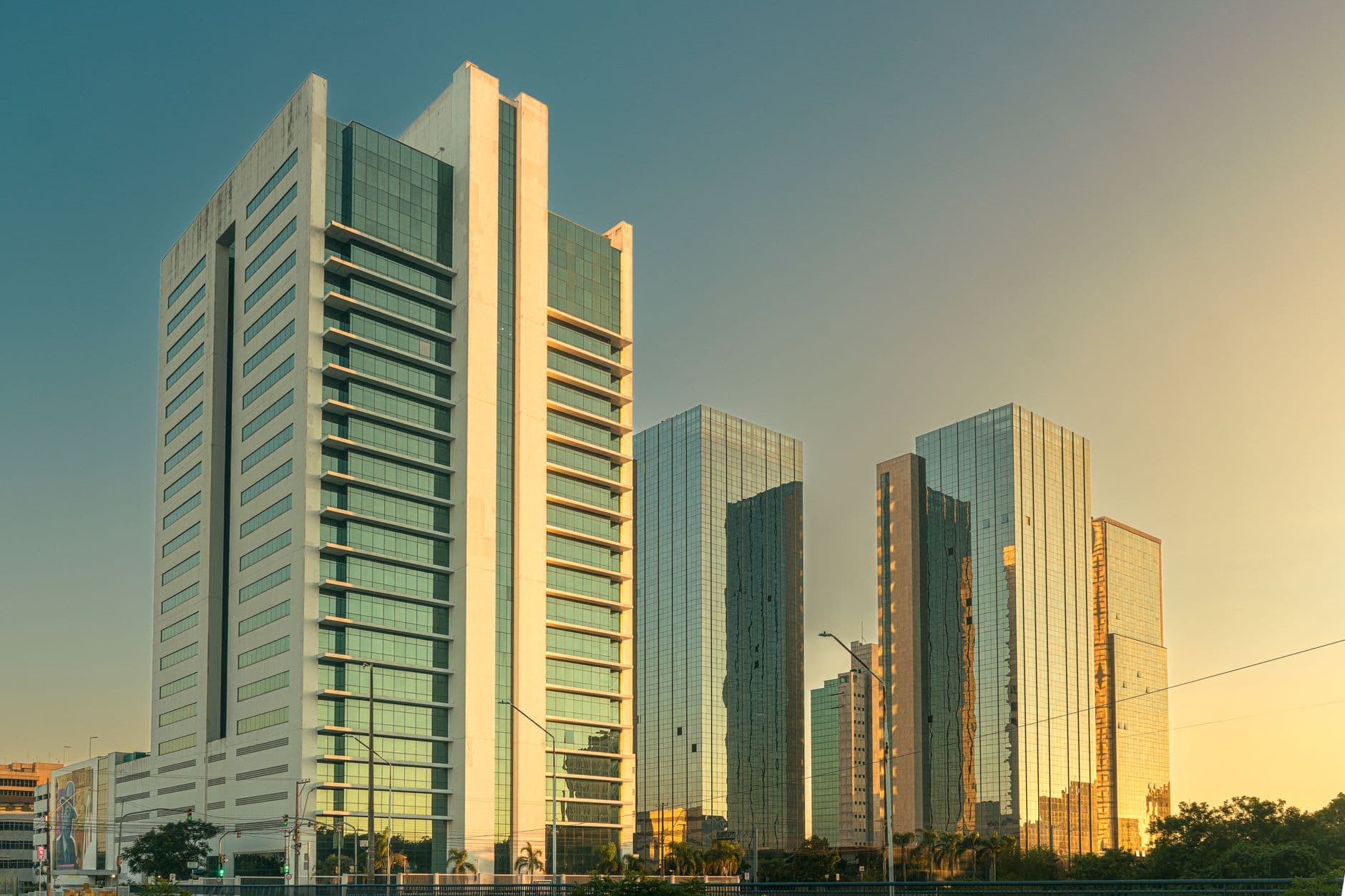 A row of modern skyscrapers reflecting sunset light in Porto Alegre, Brazil.