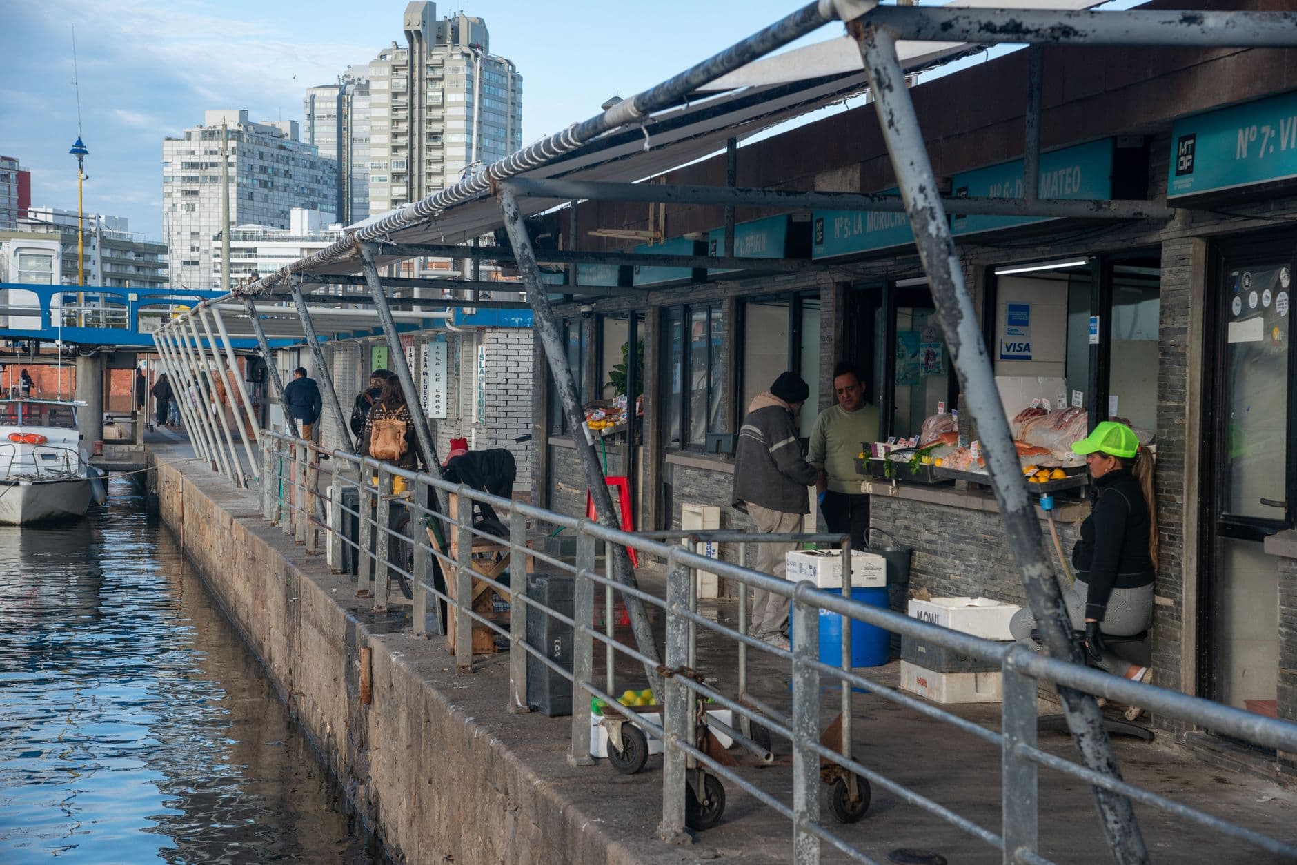 Local vendors selling fresh seafood at Punta del Este harbor on a sunny day