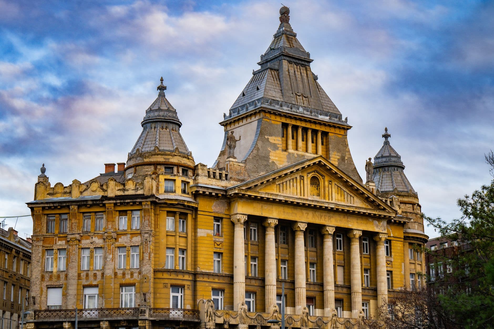 A stunning view of a historic building in Budapest, showcasing its architectural beauty during dusk.