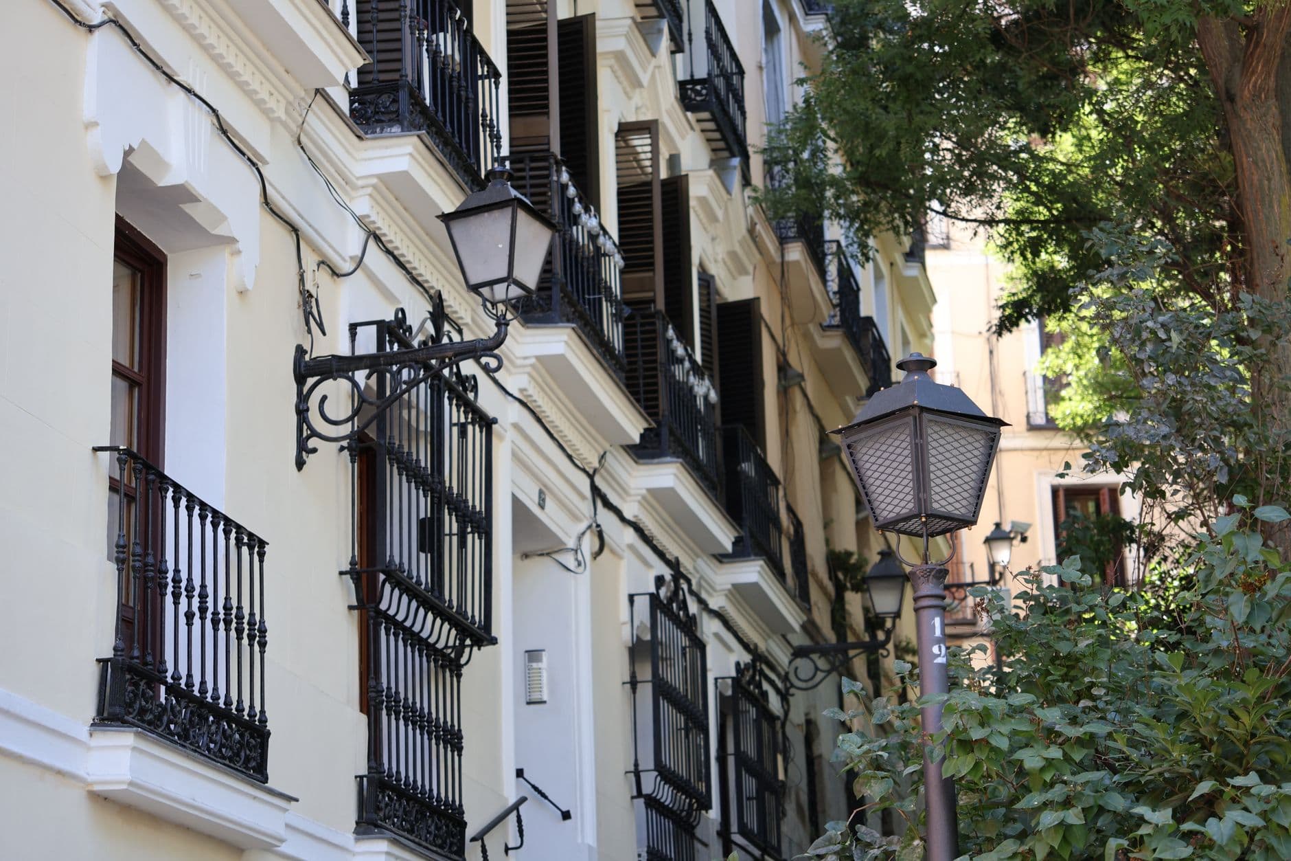 A picturesque view of classic European buildings and street lamps, offering a quaint urban scene.