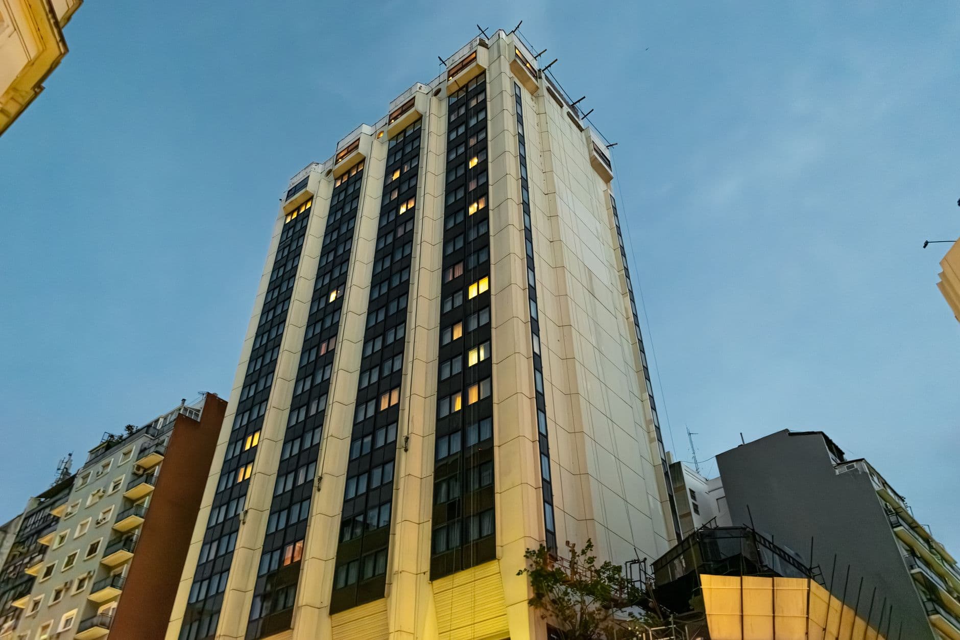 A tall building in Buenos Aires cityscape against a twilight sky.