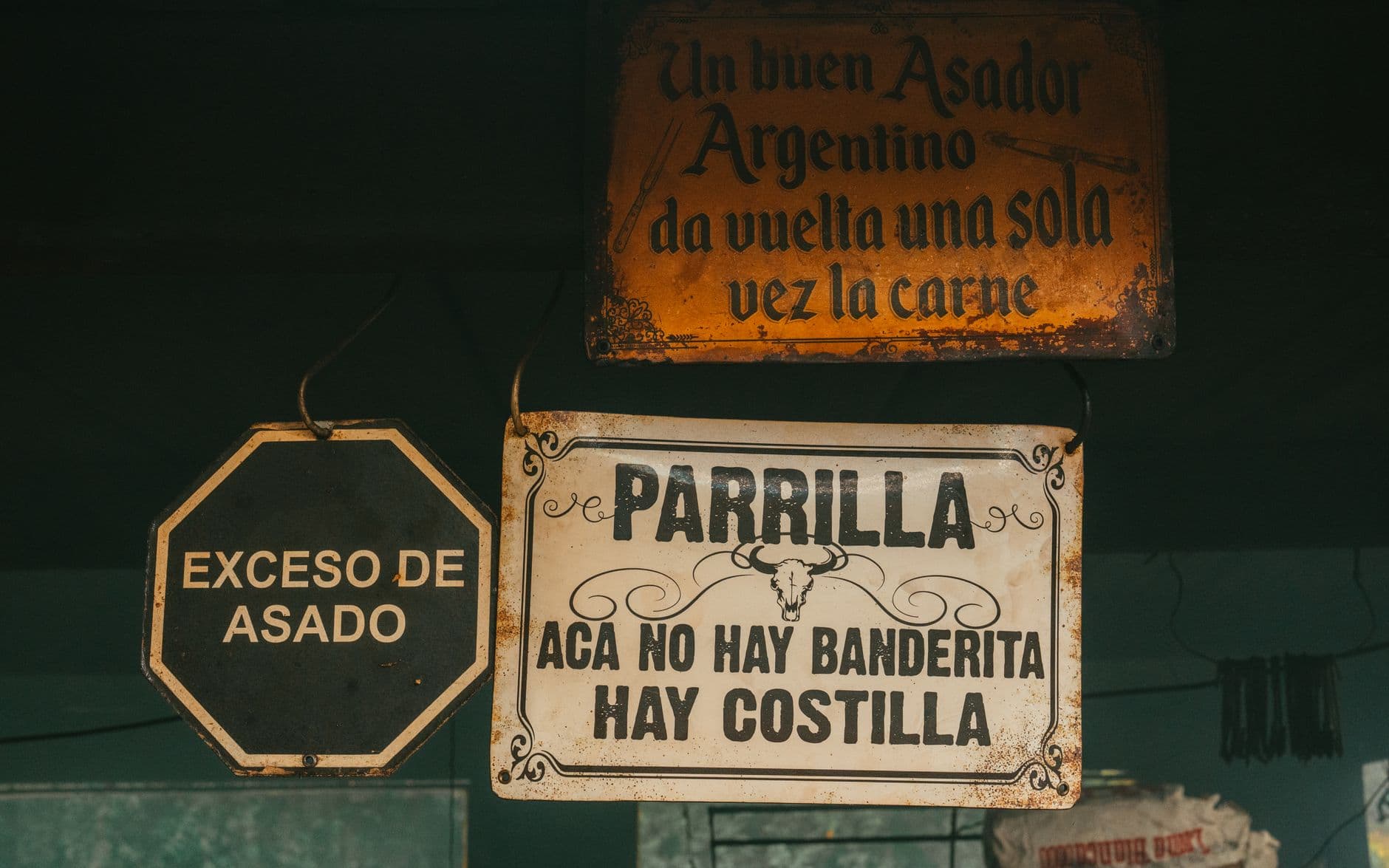 Rustic Argentine asado signs photographed in Uribelarrea, Argentina.