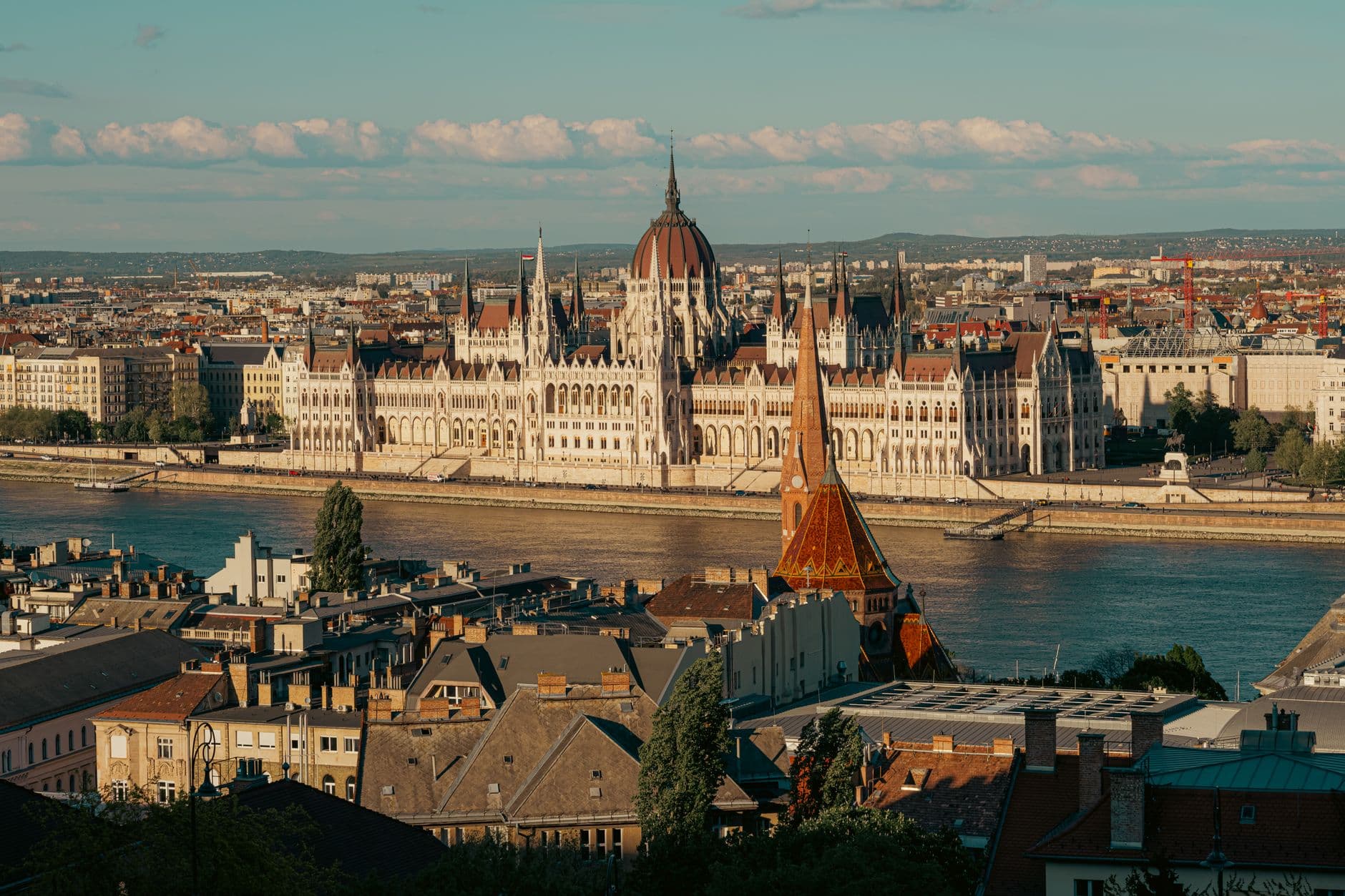A stunning view of the Hungarian Parliament building on a sunny day in Budapest by the Danube River.