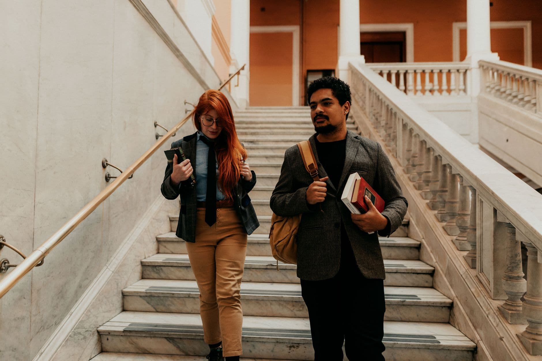 Two university students walking down stairs in a historic building in Buenos Aires, Argentina.