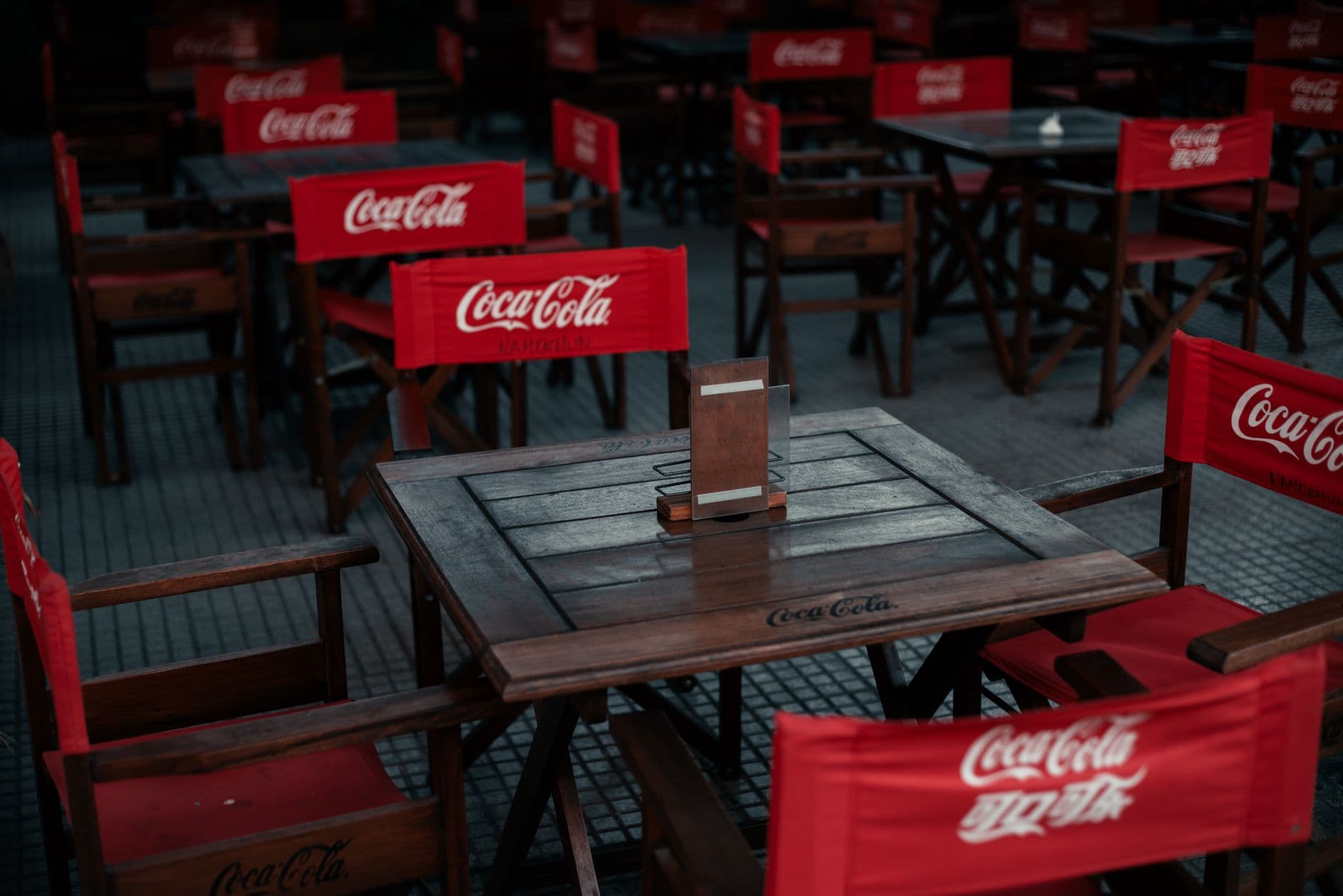 An outdoor café with Coca-Cola branded chairs in Buenos Aires, Argentina.