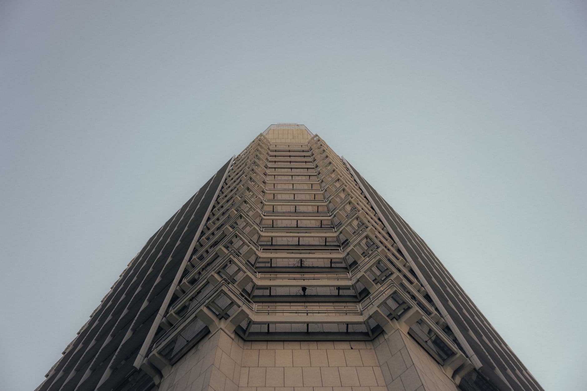 Striking perspective of a Frankfurt skyscraper showcasing modern architectural design against a clear sky.