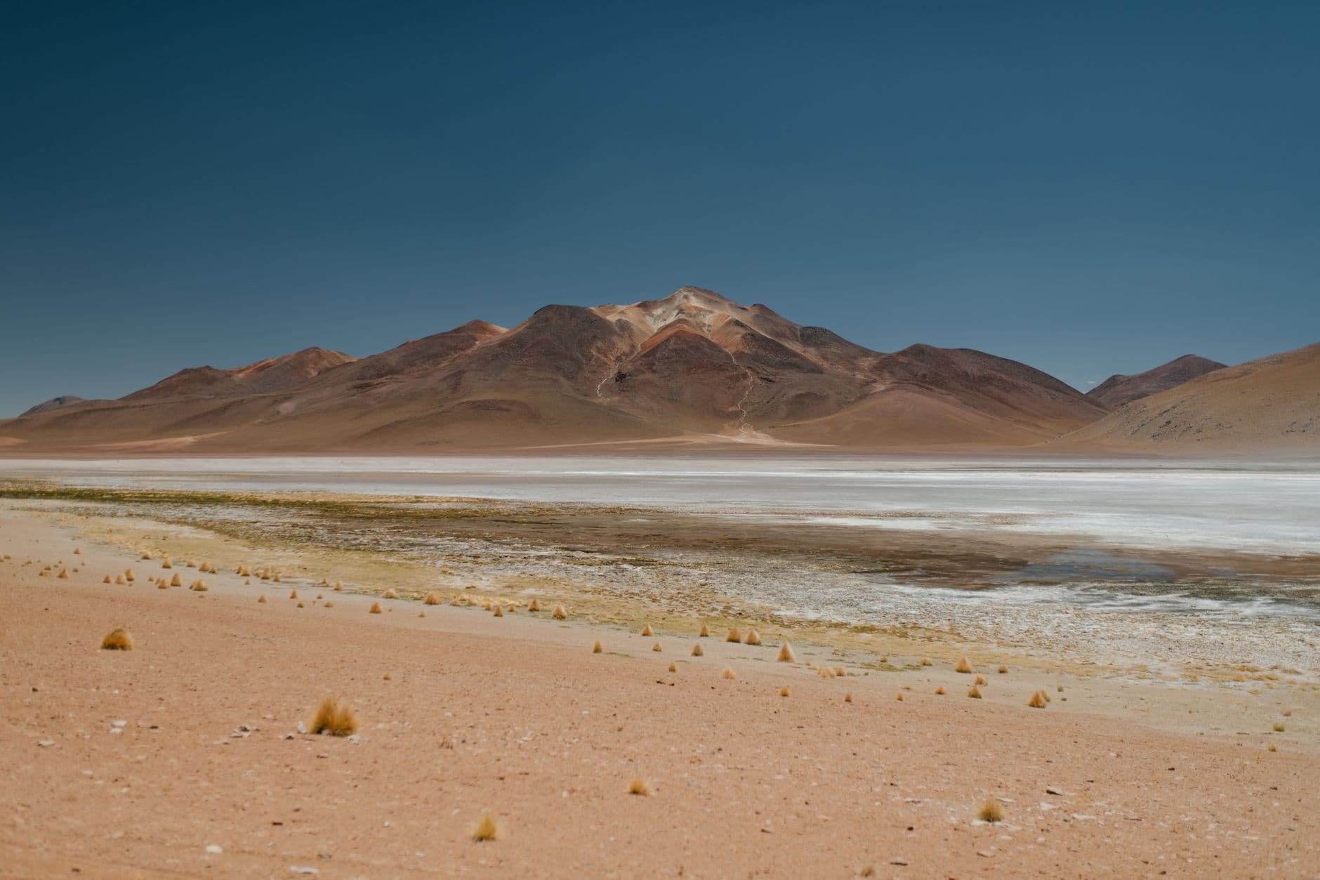 A captivating view of a barren desert landscape with a rugged mountain in Bolivia.