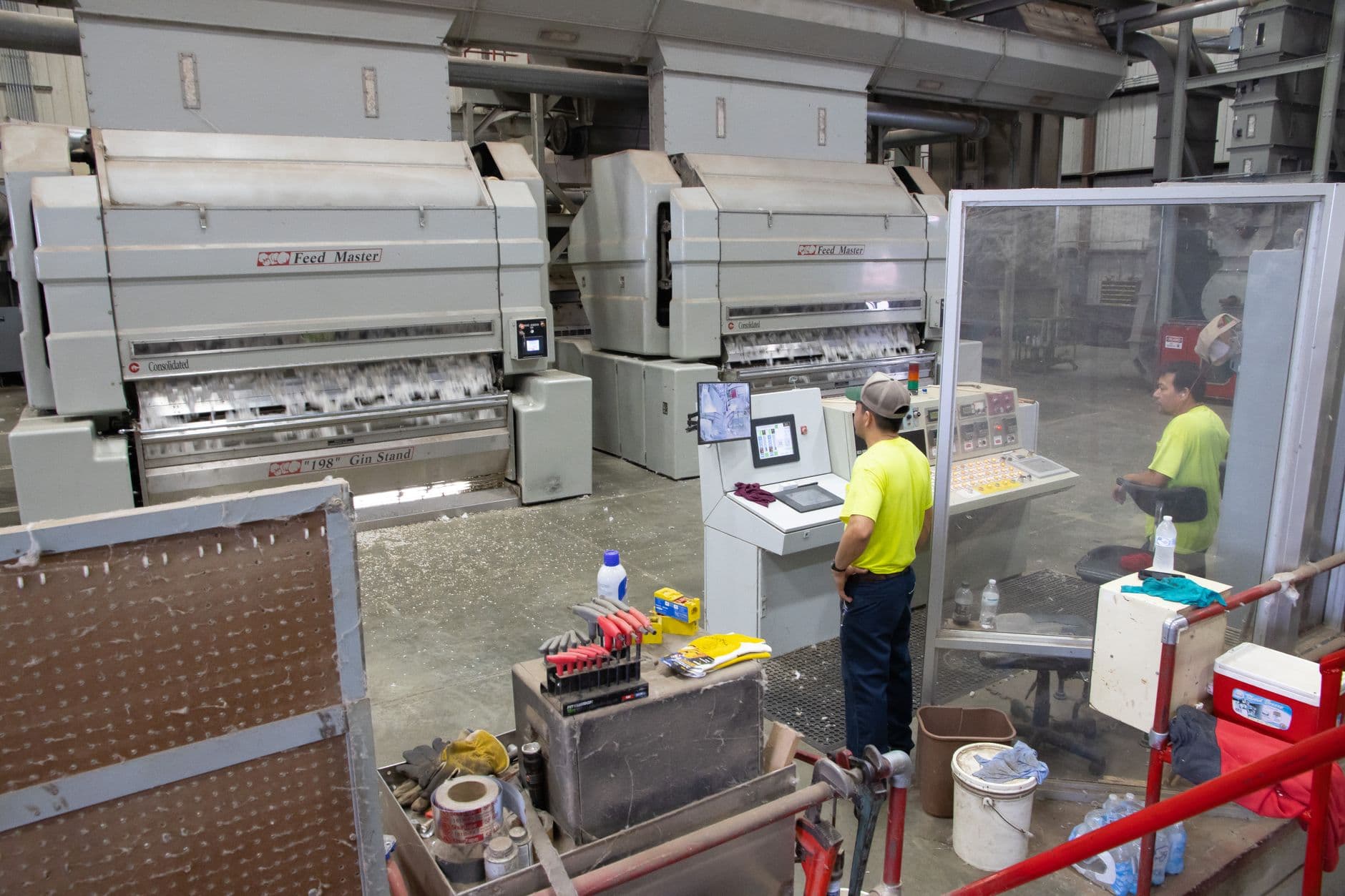 Workers operating machinery in a cotton gin factory in North Carolina