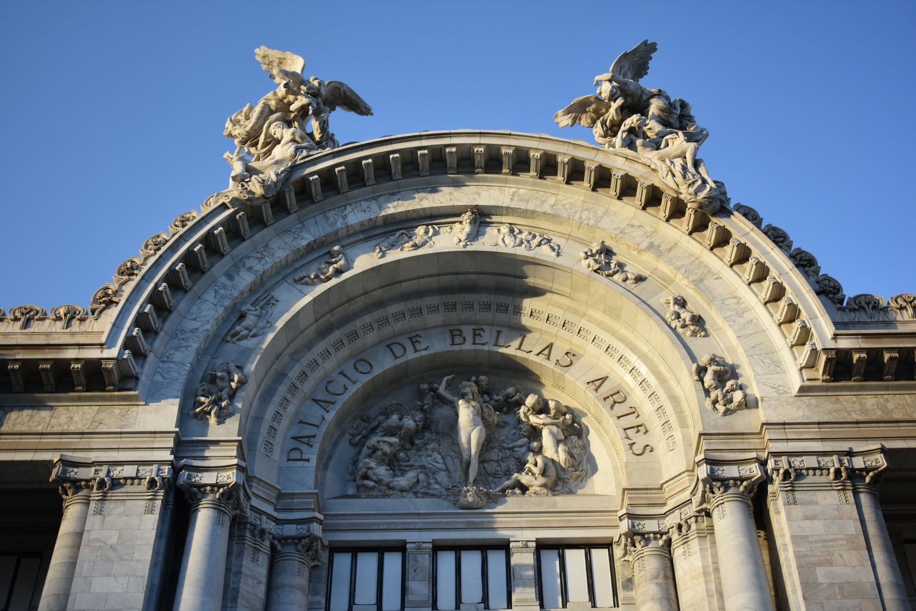 Detailed view of the ornate facade of Palacio de Bellas Artes in Mexico City showcasing neoclassical architecture.