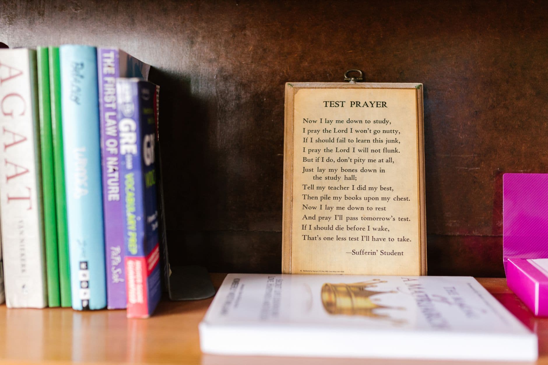 Cozy bookshelf featuring a humorous test prayer among colorful educational books.