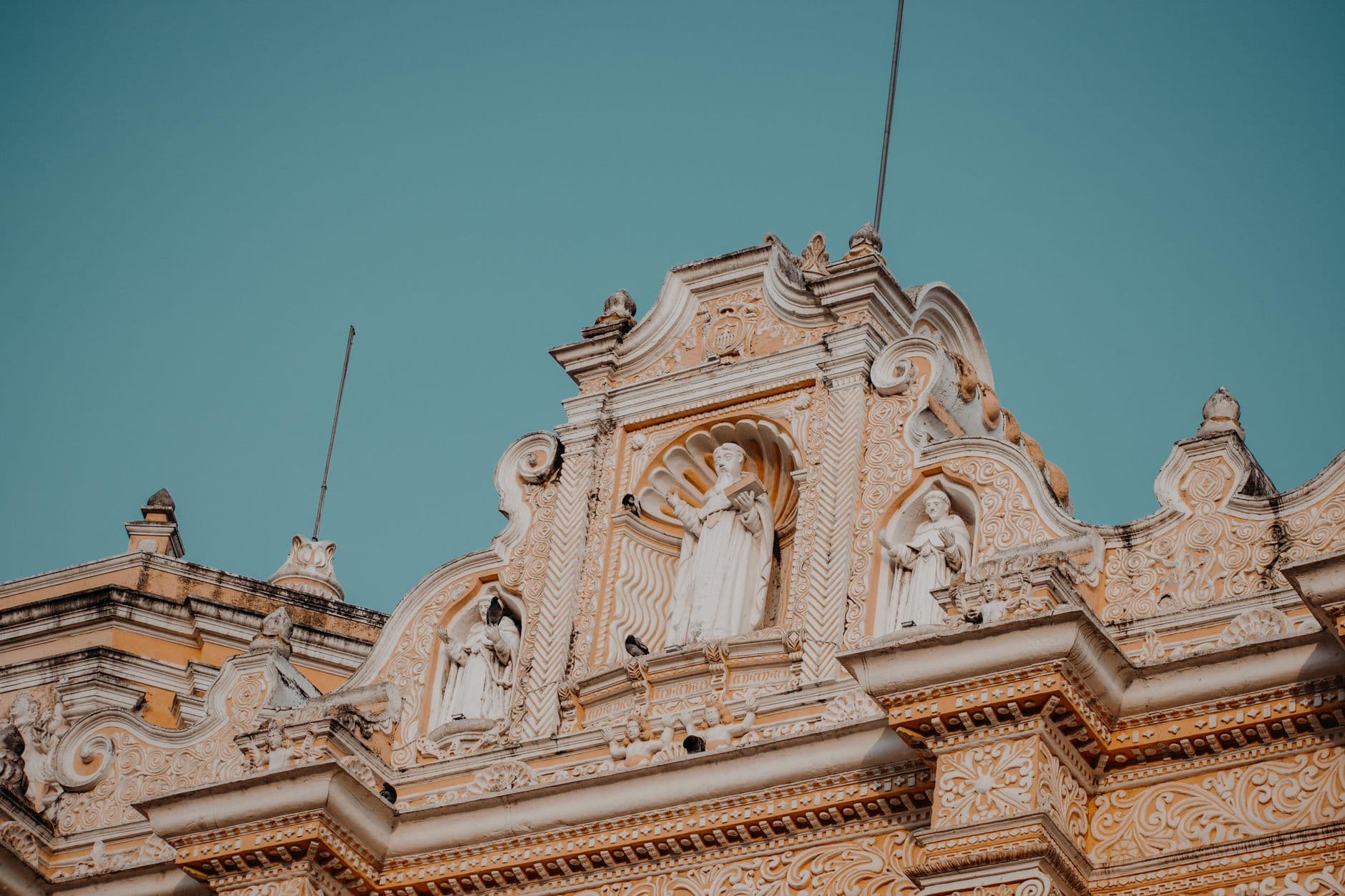 Exquisite baroque facade of La Merced Church, showcasing elaborate sculptures in Antigua, Guatemala.