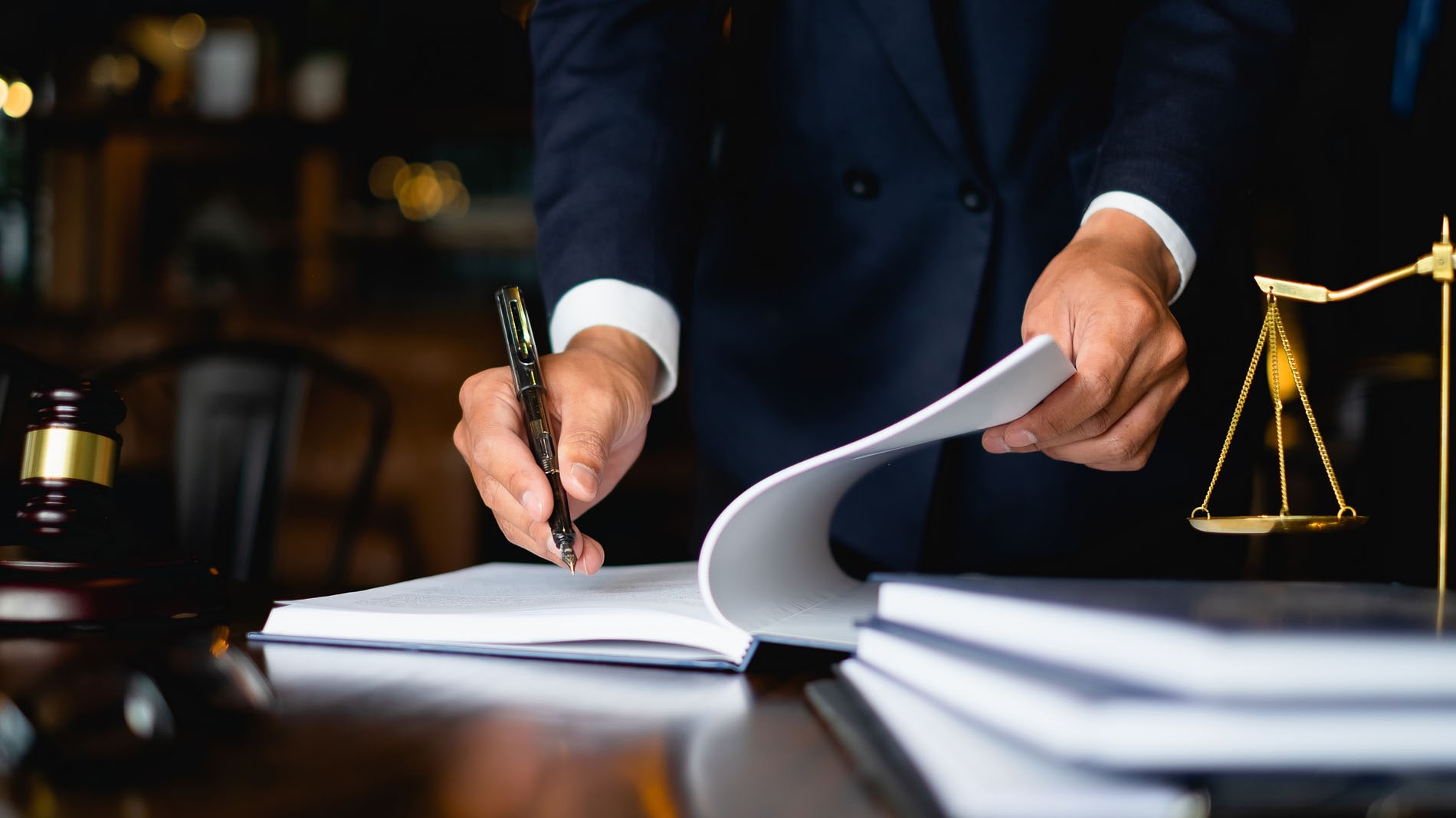 Close up lawyer businessman working or reading lawbook in office workplace for consultant lawyer concept.