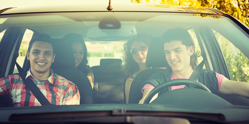 Happy friendship ready for a vacation inside a car